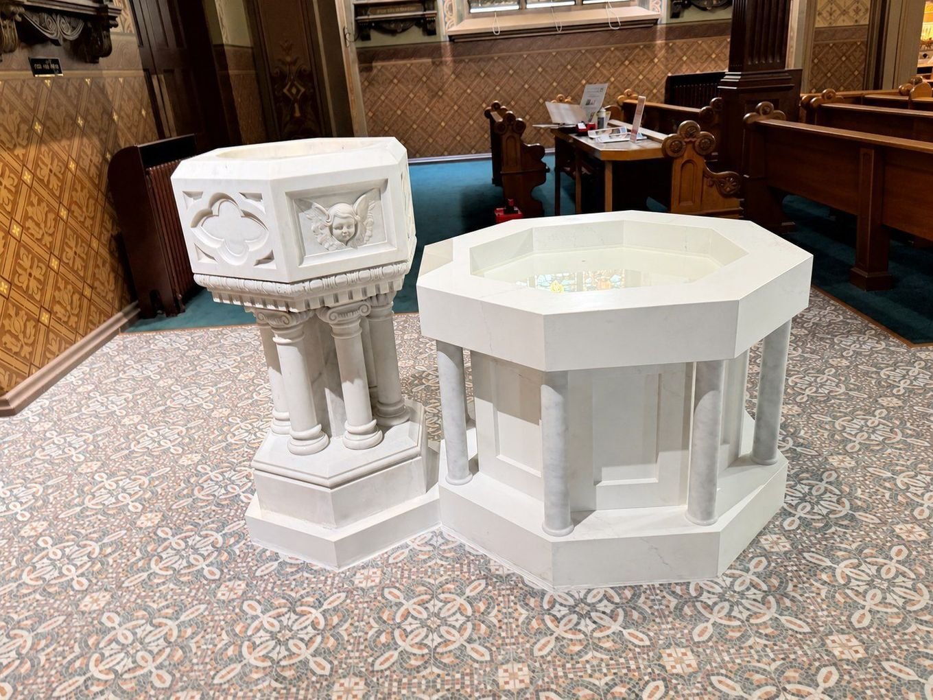 Completed font arrangement with the restored historic pedestal font beside the new octagonal marble basin.