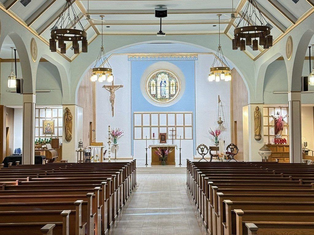 Completed Immaculate Conception interior with the tile aisle and restored sanctuary finishes.