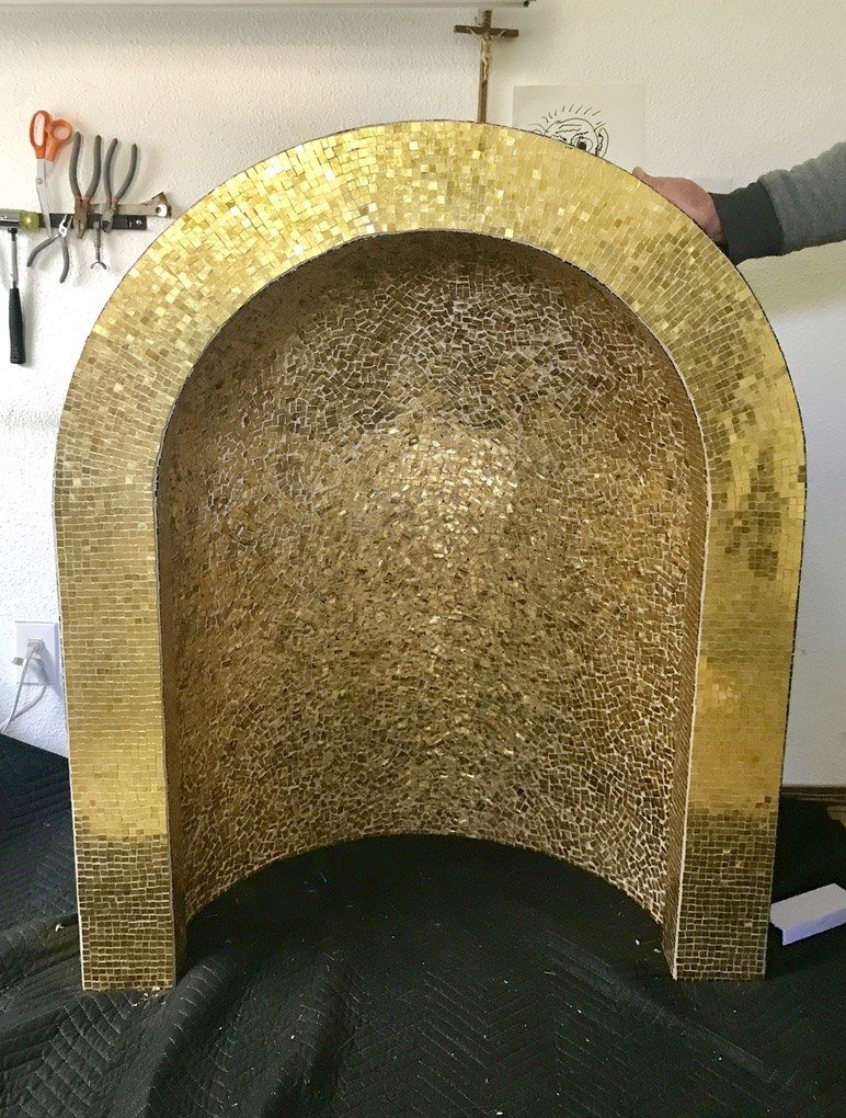 Arched gold mosaic tabernacle niche in the workshop before installation.