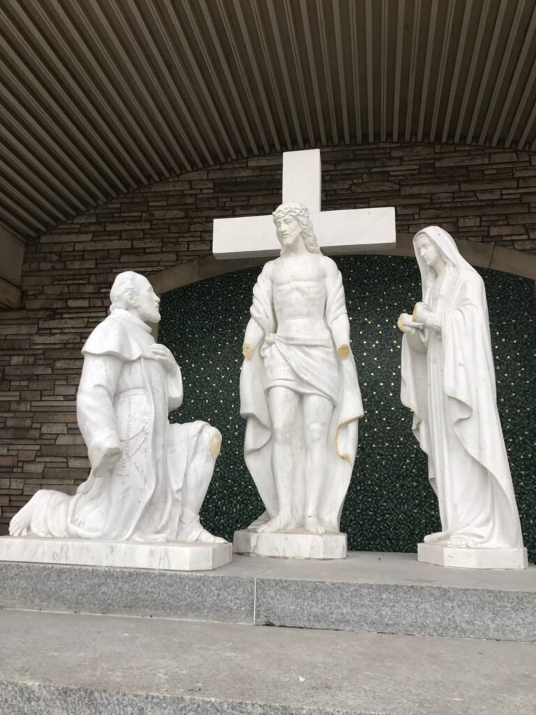 Exterior marble figure group at St. Moses the Black before restoration.