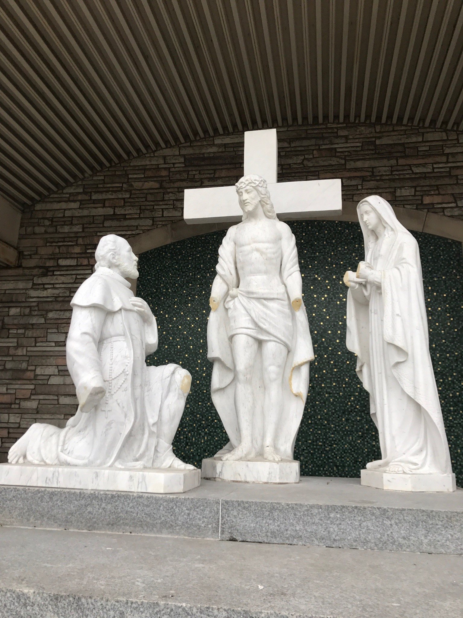Exterior marble figure group at St. Moses the Black before restoration.