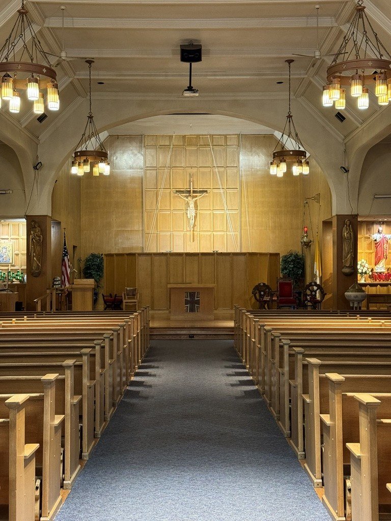 Immaculate Conception before remodeling, with the carpeted aisle and paneled sanctuary.