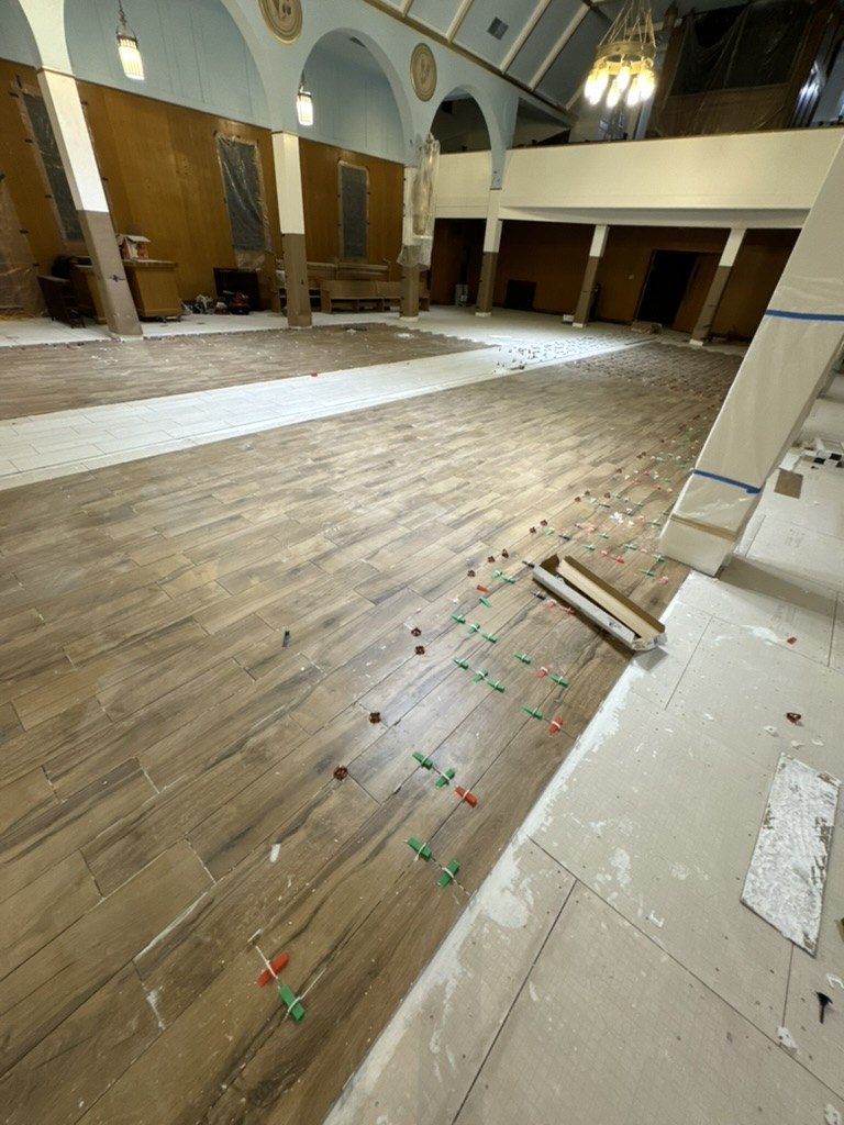 Exposed wooden floor in the nave during floor preparation.