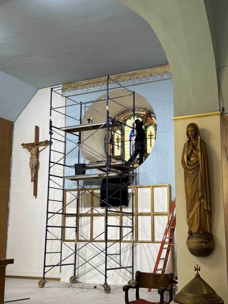 Scaffolding beside the round stained glass window during sanctuary work.