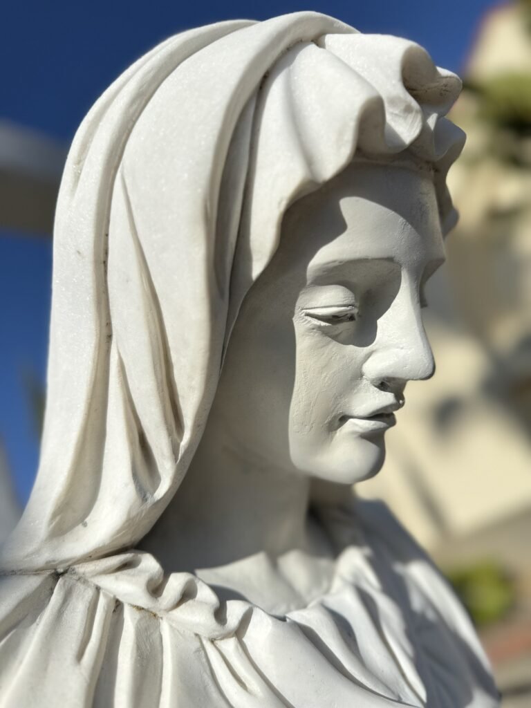 Close side view of Mary's face and veil after restoration.