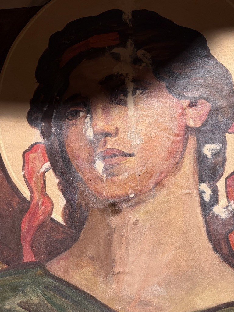 Close view of a painted face with losses through the hair, nose, mouth and neck.