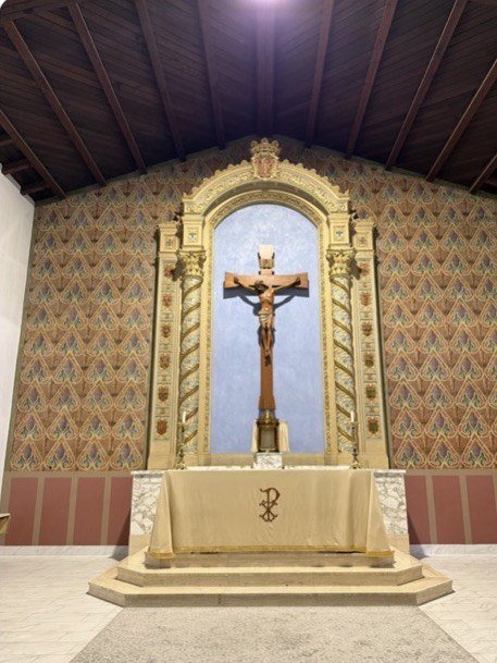 Crucifix within the blue reredos niche above the altar at St. Anne's.
