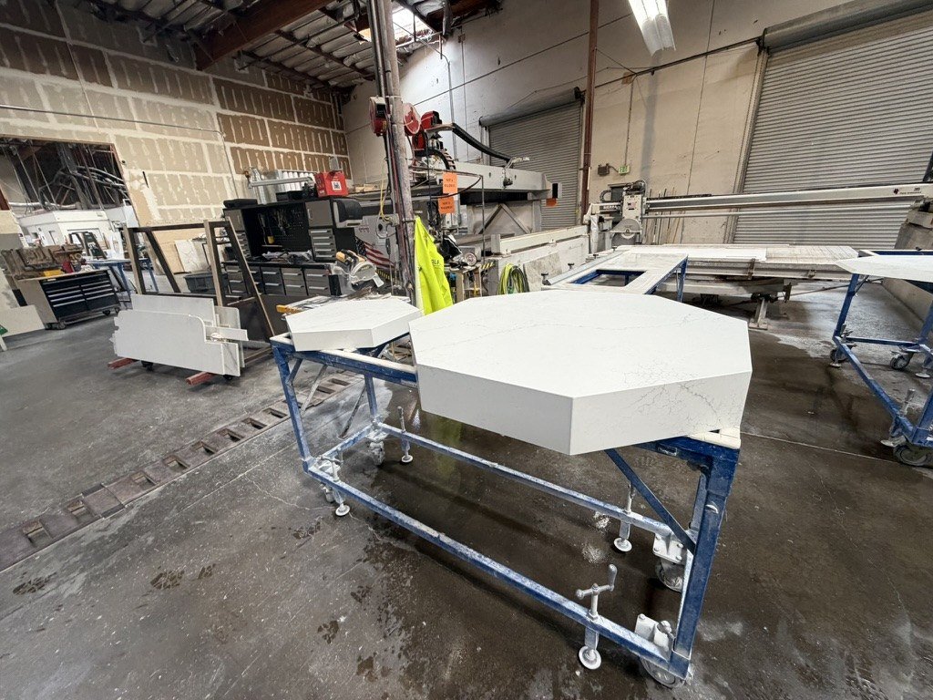 Octagonal marble slab and shaped components for the new font arrangement on workshop tables.