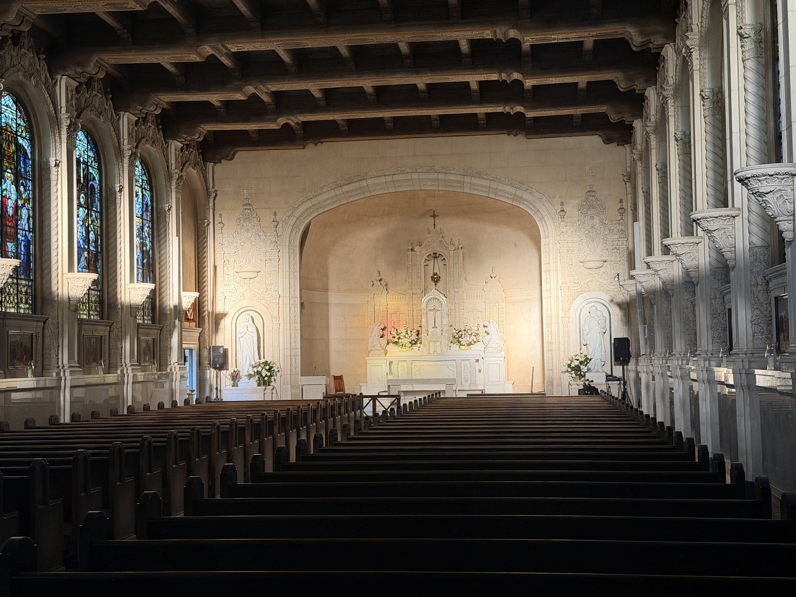 Saint Vincent Church interior with rows of pews, tall side windows and a decorated ceiling